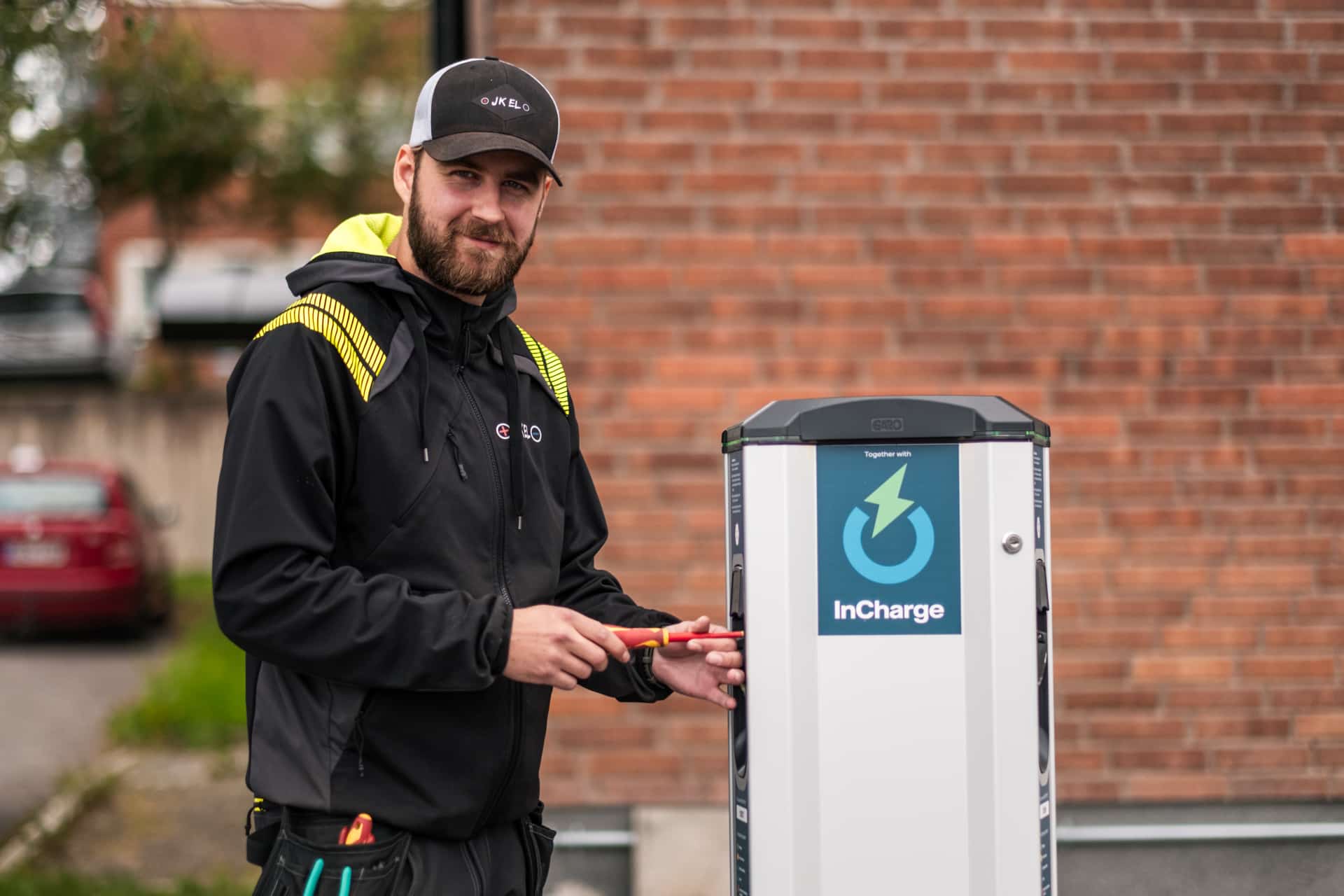 Elektriker vid en laddbox för elbil